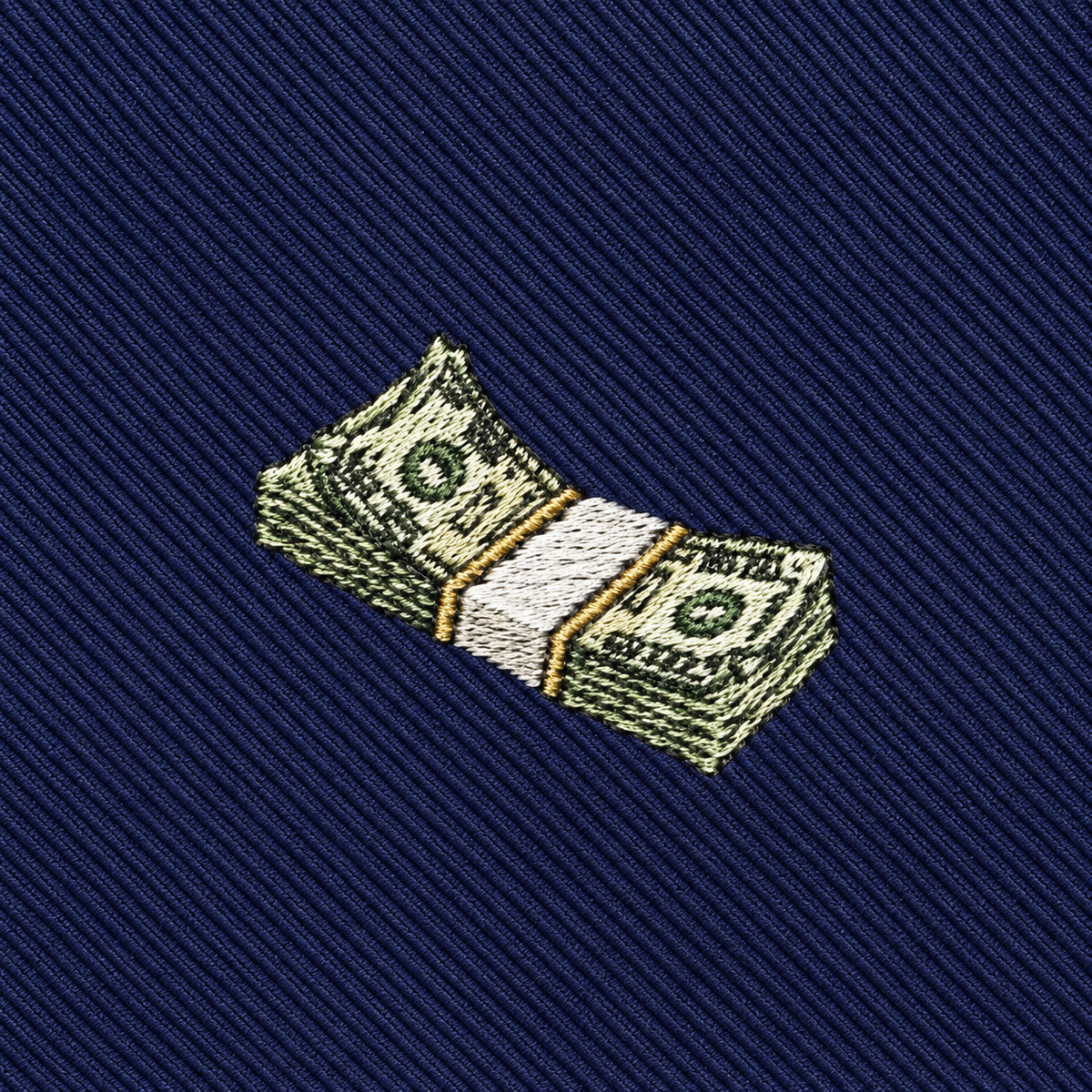 Add a playful flair to your collection with this Cash Skinny Tie, featuring an embroidered stack of dollar bills wrapped in a white band and displayed on dark blue, diagonally striped fabric—an ideal novelty necktie for cash enthusiasts.
