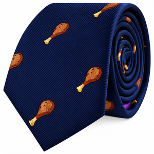 The Chicken Skinny Tie is a blue necktie featuring a playful pattern of small cooked drumsticks scattered across the fabric—an eye-catching design that adds a touch of fun to any outfit.