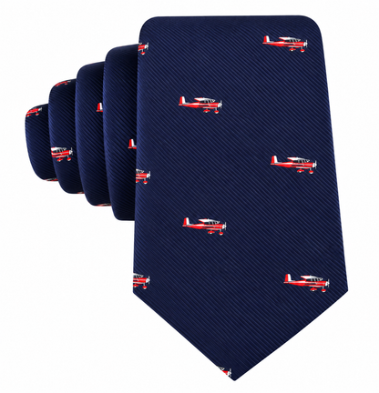 The Classic Aircraft Skinny Tie is a navy blue necktie with a subtle diagonal stripe pattern, accented by small red and white airplane motifs evenly spaced throughout—an ideal aviation-themed skinny tie and the perfect gift for pilots.