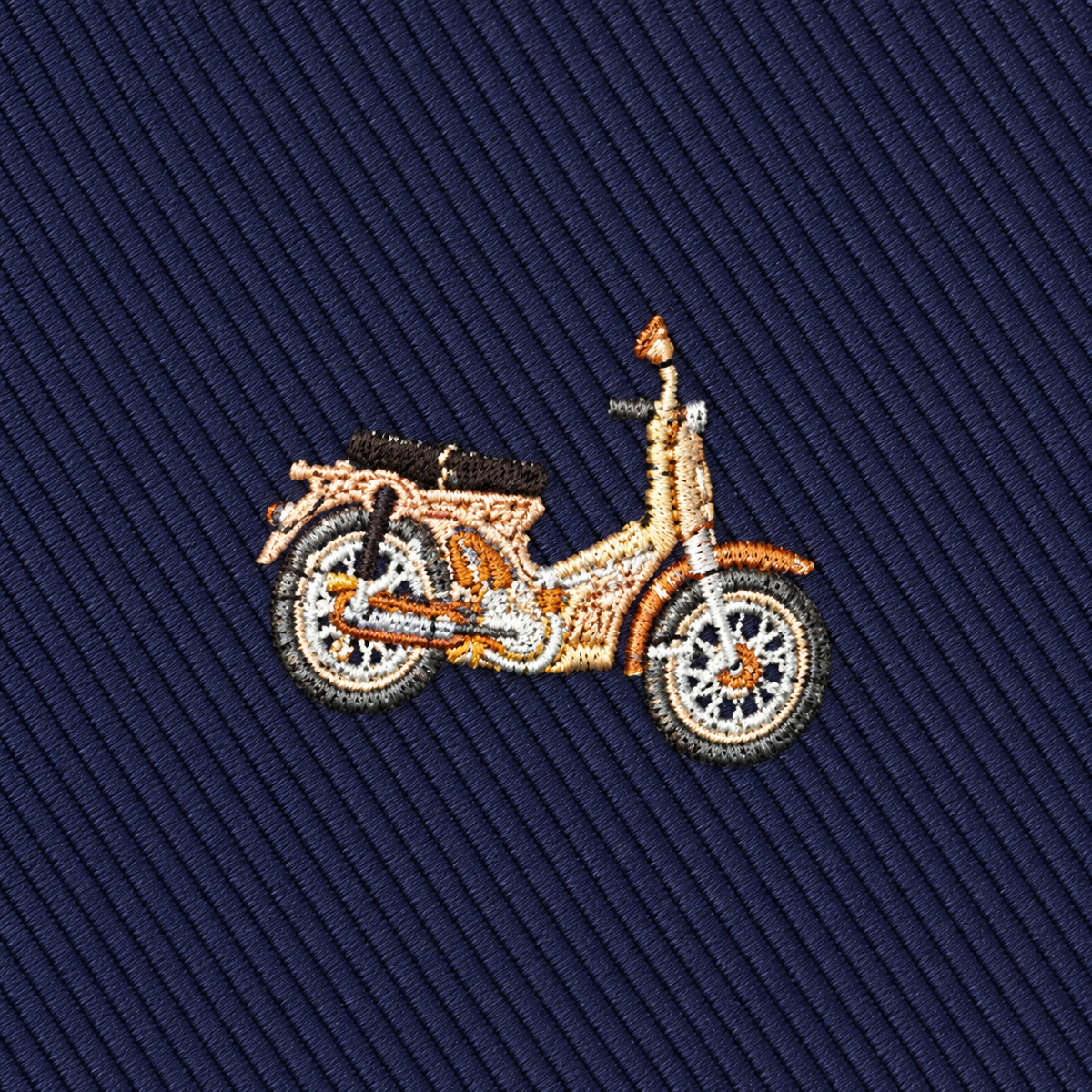 The Classic Motorbike Skinny Tie features an embroidered vintage-style motorcycle on dark blue, diagonally textured fabric—making it the perfect biker gift and a unique accessory for enthusiasts who appreciate classic flair.