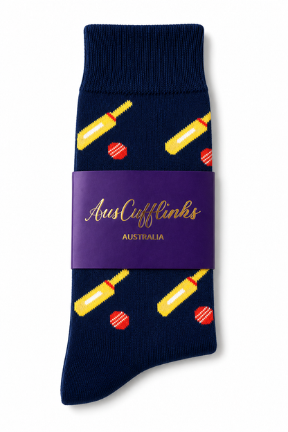 Cricket Bat & Ball Socks: Navy blue socks featuring yellow cricket bats and red balls, packaged with a purple AusCufflinks Australia band—an ideal unique gift for cricket fans.