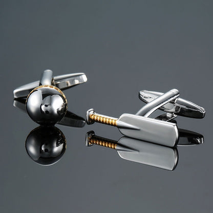 Two metallic Cricket Cufflinks rest on a reflective surface: one shaped like a cricket ball and the other like a cricket bat. This perfect accessory enhances a true gentleman's style, ideal for those who appreciate the finer details of life and sport.