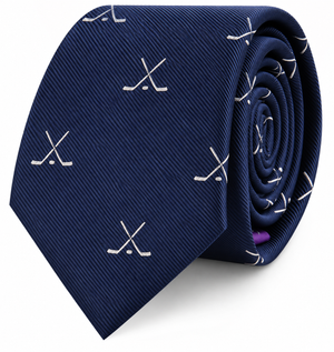 Presenting the Crossed Ice Hockey Skinny Tie: a navy blue tie adorned with a pattern of crossed white hockey sticks, shown rolled neatly against a white background—an ideal sports accessory for any dedicated fan.