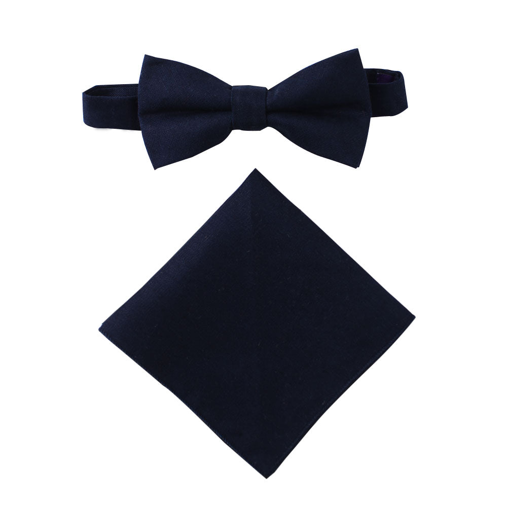 A display of timeless elegance, the Dark Forest Navy Cotton Bow Tie & Pocket Square Set graces a plain white background.