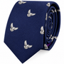 Presenting the Dove Skinny Tie: a rolled-up dark blue accessory adorned with a repeating pattern of small, embroidered silver doves with outstretched wings. This symbolic tie embodies sophistication and charm, making it the perfect choice for those seeking refined style.