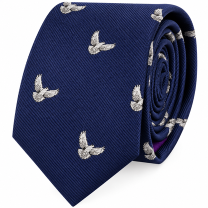 Presenting the Dove Skinny Tie: a rolled-up dark blue accessory adorned with a repeating pattern of small, embroidered silver doves with outstretched wings. This symbolic tie embodies sophistication and charm, making it the perfect choice for those seeking refined style.