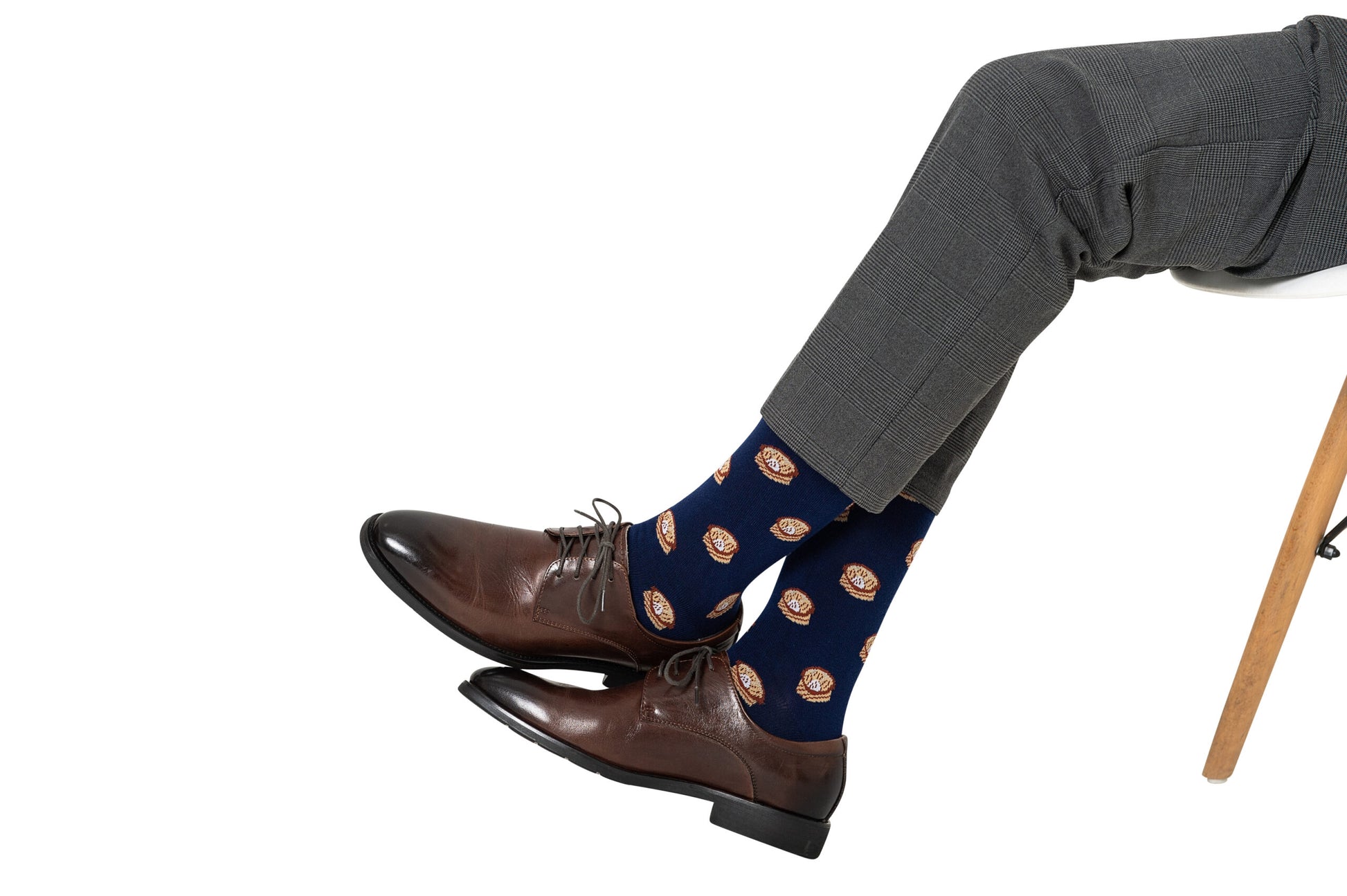 A pair of legs with brown shoes and Dumpling Socks.