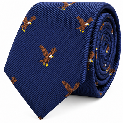 The Eagle Bird Skinny Tie is a blue slim-cut tie, rolled up for display, and features a repeating pattern of embroidered bald eagles in flight.