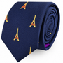 A rolled navy blue Eiffel Tower Skinny Tie featuring a repeating Eiffel Tower pattern.