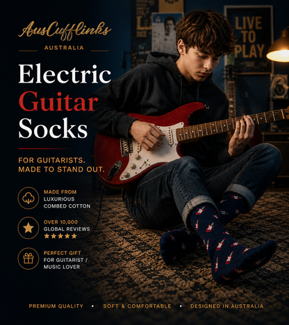 A teen sits on a rug, playing a red electric guitar and wearing navy Electric Guitar Socks with red guitar designs—highlighted as the perfect gift for music lovers and guitarists.