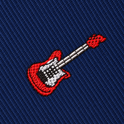 An embroidered red electric guitar on a dark blue ribbed Electric Guitar Skinny Tie.