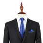 A black suit with a white dress shirt and the Pink Flamingo Navy Skinny Tie & Pocket Square Set displayed on a dress form.