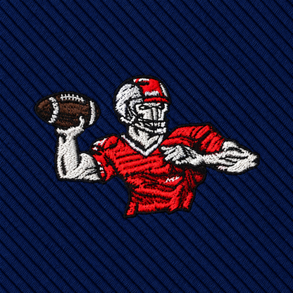 Football Hail Mary Skinny Tie featuring an embroidered patch of a football player in a red jersey throwing a football against a dark blue diagonal-striped background.
