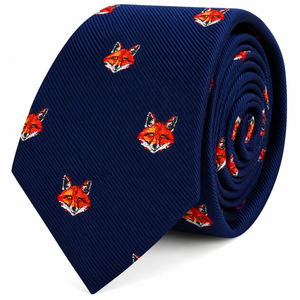 A rolled navy blue Fox Head Skinny Tie featuring a repeating design of orange fox faces.