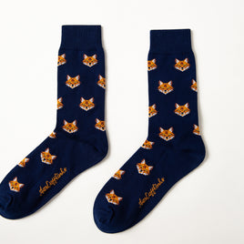 Fox Head Socks: A pair of navy blue novelty socks with a repeating fox face design and yellow script near the toes, shown on a white background.