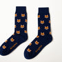 Fox Head Socks: A pair of navy blue novelty socks with a repeating fox face design and yellow script near the toes, shown on a white background.