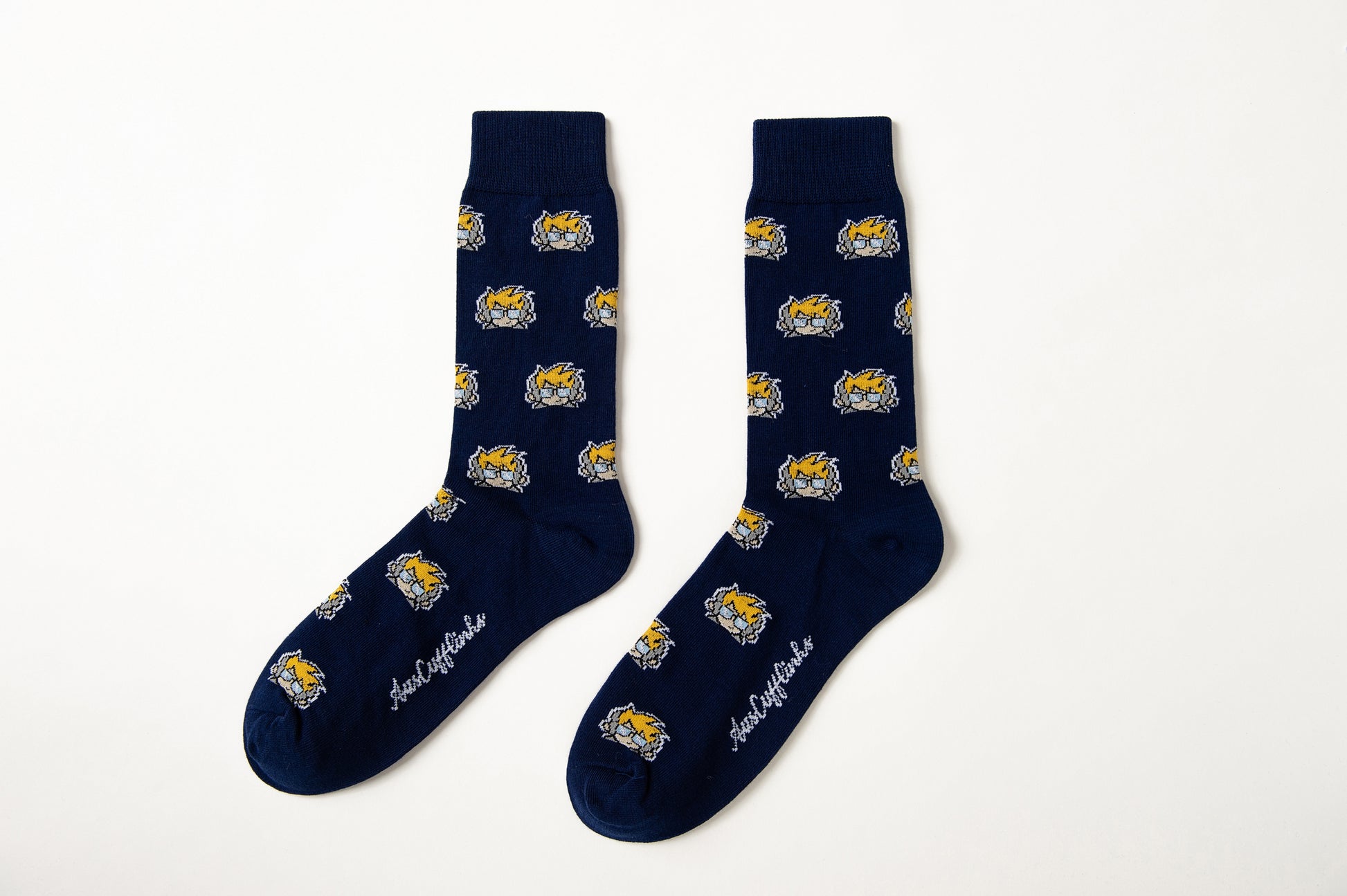 A pair of Gamer DJ Socks in navy blue, featuring repeating yellow and white wildcat faces and white cursive text by the toes, displayed against a white background.