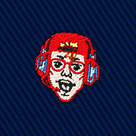 An embroidered patch of a stylized face wearing red headphones and glasses on a navy blue diagonal-ribbed Gamer Face Skinny Tie.