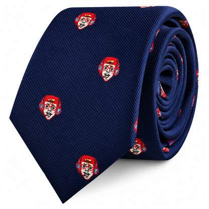 A navy blue Gamer Face Skinny Tie featuring a repeating pattern of small red-headed character faces wearing blue headphones.