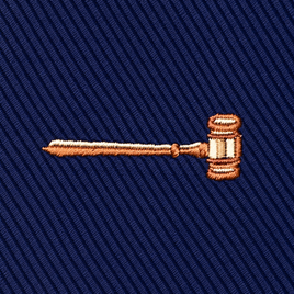 Embroidered gavel icon on a navy blue diagonal-ribbed Gavel Skinny Tie.