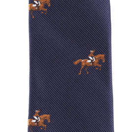 Close-up of the Giddy Up Horse Racing Skinny Tie, a navy blue tie with an embroidered repeating pattern of horses and jockeys in brown, white, and black—perfect for derby day accessories.