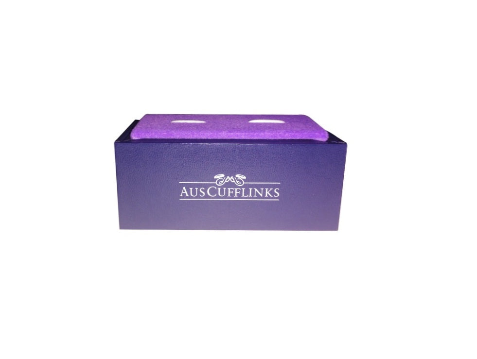 A purple cufflink box featuring the "AUS CUFFLINKS" logo on the side, exuding a regal charm that beautifully contrasts with its sleek design, makes a perfect home for the Gold on Black Cufflinks.