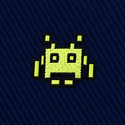 An embroidered lime green pixelated alien from a Green Space Invader Skinny Tie centered on a dark blue ribbed fabric.
