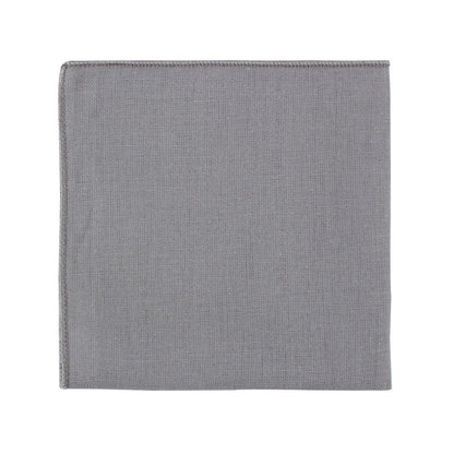 A neatly folded pocket square from the Grey Cotton Skinny Tie & Pocket Square Set, showcasing its versatile style, rests gracefully against a crisp white background.