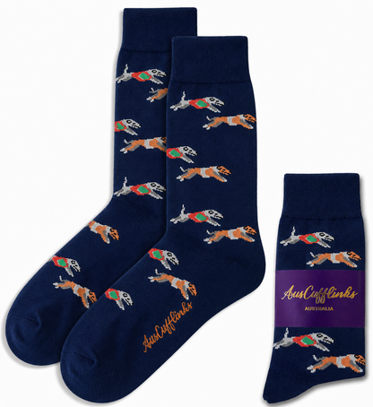 Greyhound Racing Socks in navy blue with running dogs in vests, plus a folded pair featuring a purple "AussieCufflinks" label—a fun and unique greyhound gift for dog lovers.