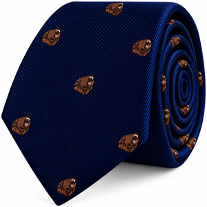 A coiled navy blue Grizzly Bear Skinny Tie featuring a repeating pattern of brown bear heads.