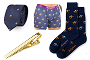 The Racing Car Bundle Pack, featuring a navy tie, boxers, and socks with gold bee patterns plus a gold tie clip, is displayed on a white background.