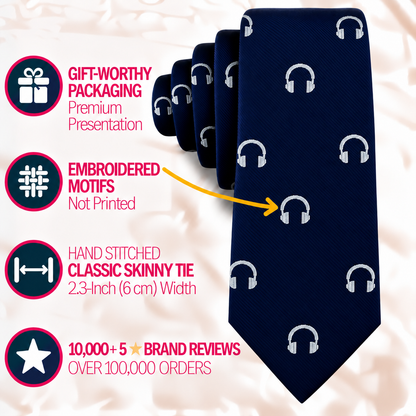A dark blue Headphone Skinny Tie featuring white headphone icons, with callouts for its gift packaging, embroidered motifs, 2.3-inch width, and high brand review ratings.