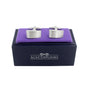 A pair of Horizontal Sweep Cufflinks, embodying linear elegance, displayed on a purple cushion inside a navy blue box labeled "AUSCUFFLINKS.