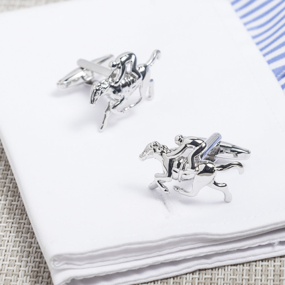 Horse Racing Cufflinks, shaped like jockeys poised to gallop, elegantly rest on a white napkin.