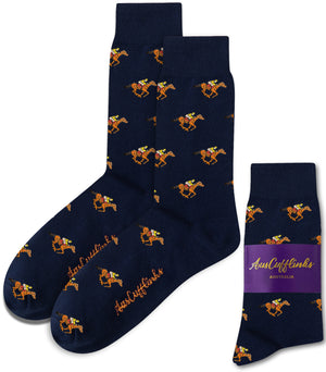 Melbourne Race Horse Socks: Navy blue socks featuring orange racehorses and jockeys, showcased with a purple AusCufflinks Australia label—an ideal gift for racing enthusiasts.