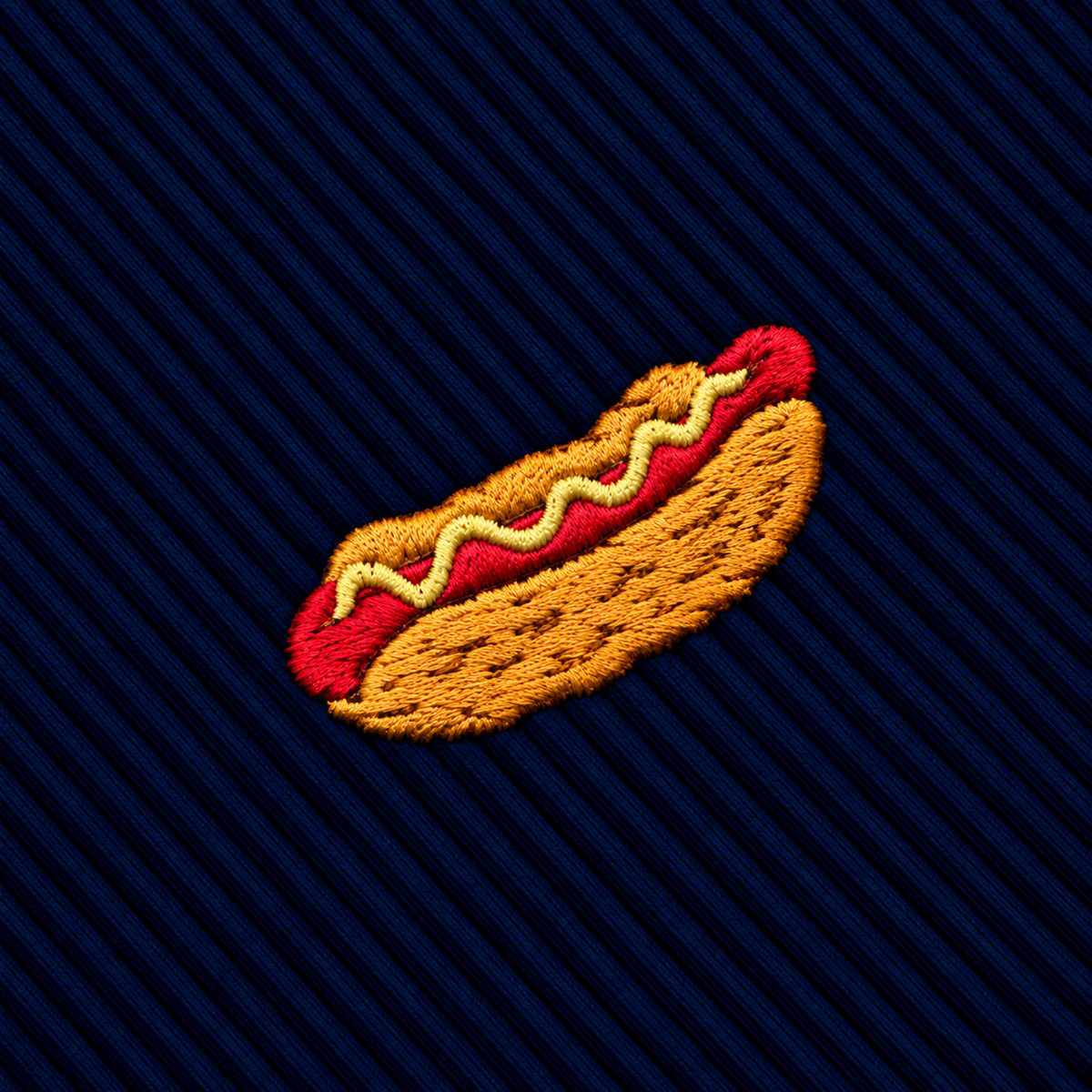 Embroidered hot dog icon on a dark blue ribbed Hotdog Skinny Tie.