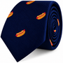 A coiled navy blue Hotdog Skinny Tie featuring an embroidered novelty pattern.
