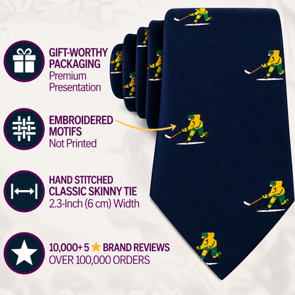 Introducing the Ice Hockey Shot Skinny Tie—a navy blue skinny tie featuring yellow and green embroidered hockey player motifs. This stylish accessory is perfect as an ice hockey tie or a thoughtful gift for any hockey lover. Showcased with icons and text highlighting its premium packaging, detailed embroidered design, and over 10,000 five-star reviews, it’s an ideal addition to any collection of men’s hockey apparel.