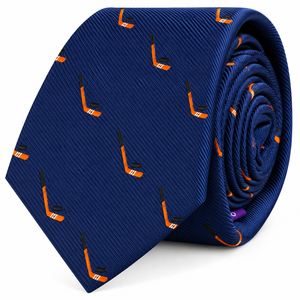 Ice Hockey Skinny Tie featuring a repeating orange and black hockey stick print on a blue background, tightly rolled and displayed on a white surface.