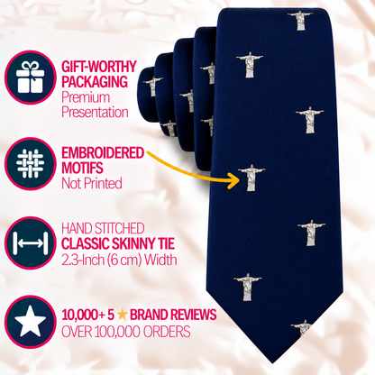 A navy blue Jesus Christ The Redeemer Skinny Tie featuring a repeating embroidered statue pattern, with infographic text detailing its premium features and dimensions.