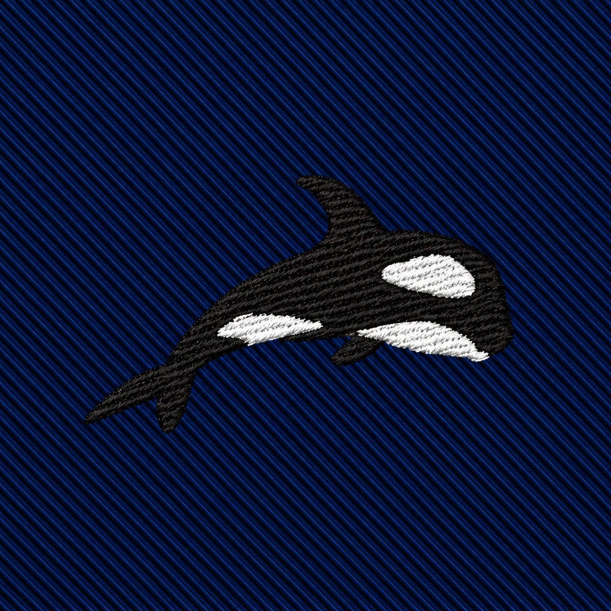 An embroidered orca on a navy blue diagonal-ribbed Killer Whale Skinny Tie.