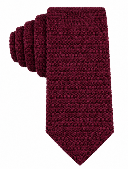 The Maroon Knitted Skinny Tie features a rolled-up design with a square textured pattern and is displayed against a plain white background—making it an ideal choice as a stylish skinny tie for men or as an elegant maroon wedding tie.