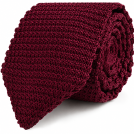 The Maroon Knitted Skinny Tie features a rolled-up design with a textured pattern and a straight, flat edge, making it the perfect stylish accessory for men.