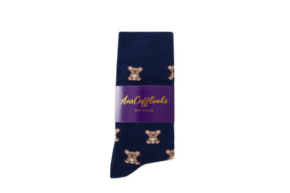 Koala Socks come in a charming style, adorned with vibrant blue tones and delightful koala designs, and they are packaged with a purple label that says "Aussie Cufflinks Australia.