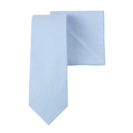 Set against a white background, the Light Blue Cotton Skinny Tie & Pocket Square Set evokes the charm of azure skies, embodying timeless style.