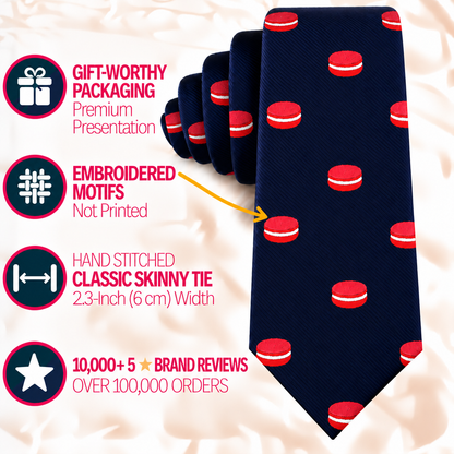 A dark blue Macaron Skinny Tie featuring a repeating macaron pattern, accompanied by four infographics highlighting gift packaging, embroidered motifs, dimensions, and brand reviews.