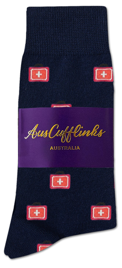 Medical Cross Socks: Navy blue socks featuring a repeating red cross pattern, designed for healthcare professionals, packaged with a purple band labeled “AusCufflinks Australia.”.