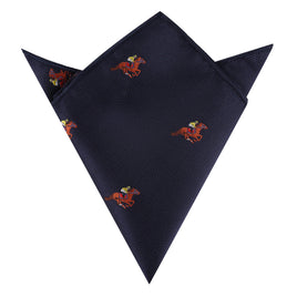 The Melbourne Race Horse Pocket Square in navy blue showcases small red horses and jockeys, neatly folded with pointed edges—an ideal, stylish accessory for the Melbourne Cup.