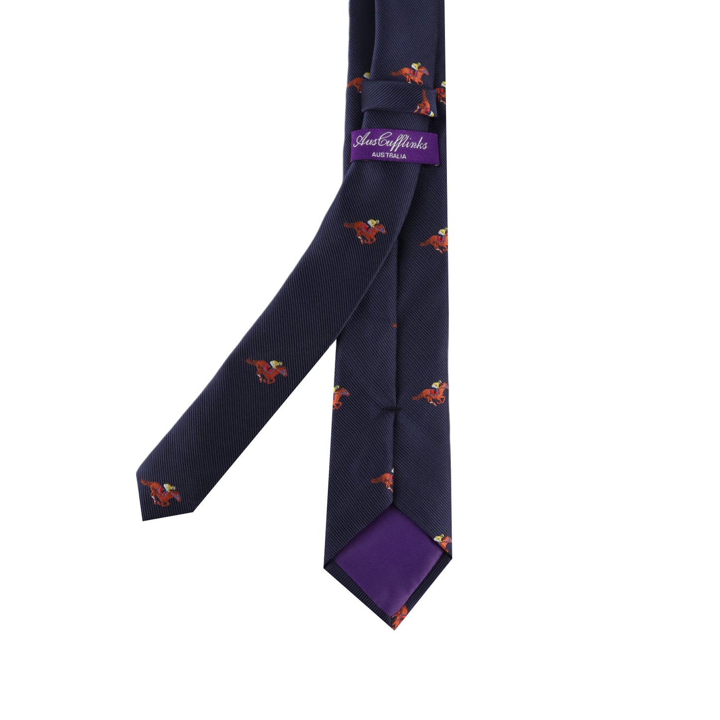 The Melbourne Race Horse Skinny Tie is a navy blue necktie with small, colorful birds and a purple "Suitsupply Limited" label on the back. Its tip is lined with purple fabric, making it ideal for Melbourne Cup style.
