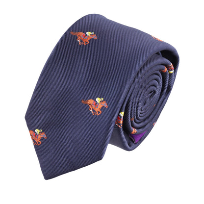 The Melbourne Race Horse Skinny Tie is a rolled-up navy blue tie with a repeating pattern of small orange embroidered horses and riders, adding equestrian charm perfect for Melbourne Cup fashion.